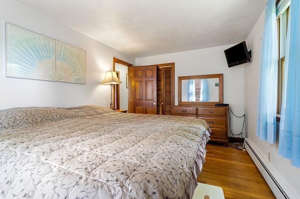 25 Pine Ridge Drive Ayer, MA 01432 - Photo 22 of 30 a bedroom with a bed and a large mirror on the dresser