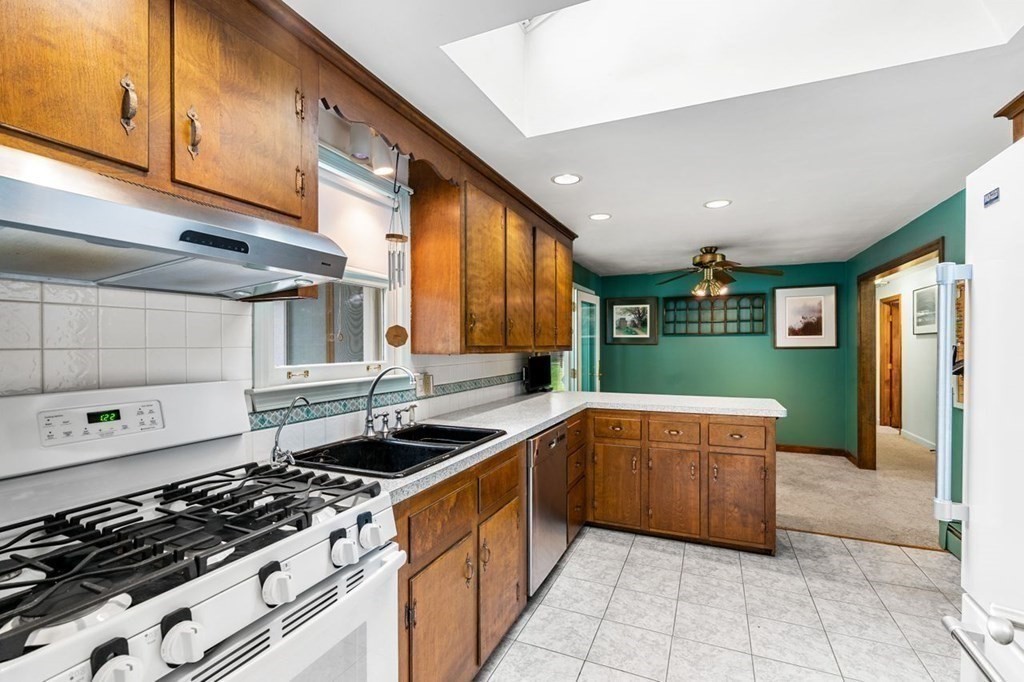 25 Pine Ridge Drive Ayer, MA 01432 - Photo 4 of 30 a kitchen with stainless steel appliances granite countertop a sink and a stove