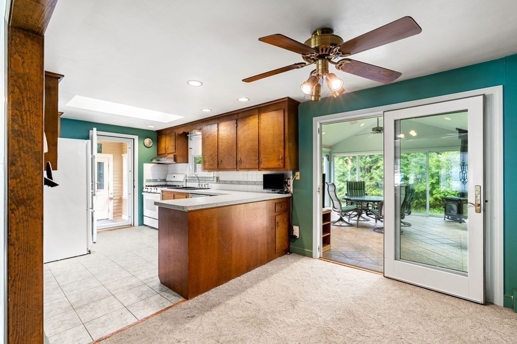 25 Pine Ridge Drive Ayer, MA 01432 - Photo 7 of 30 a kitchen with stainless steel appliances granite countertop a stove and a refrigerator
