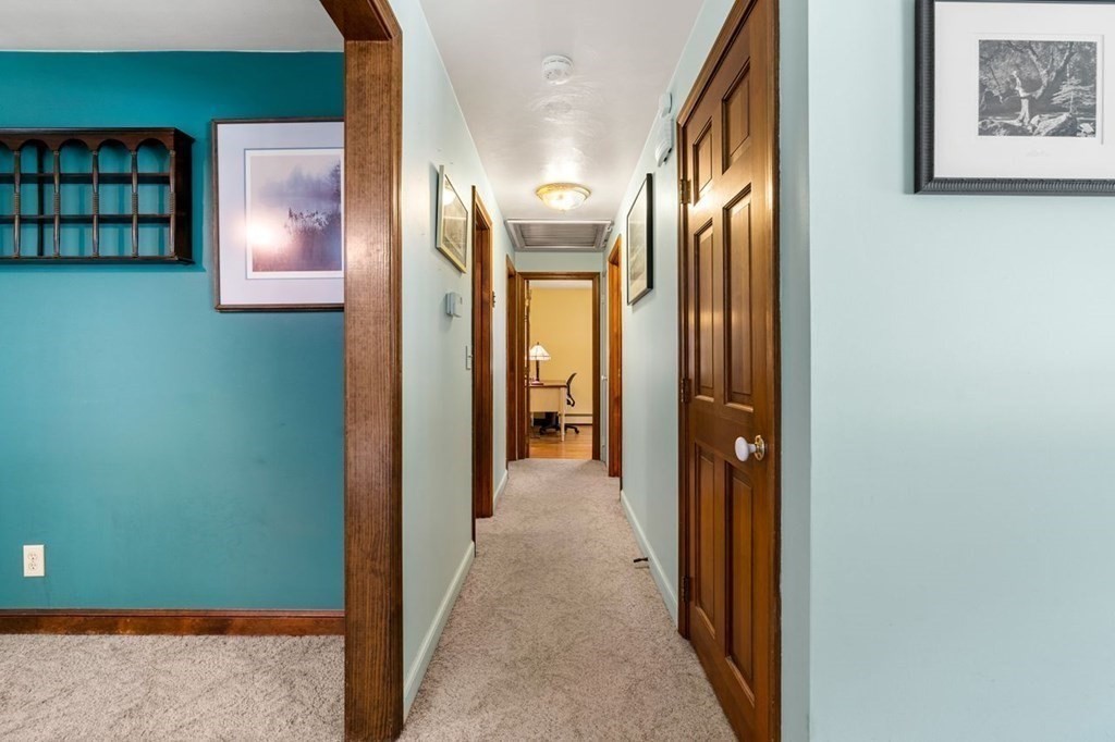25 Pine Ridge Drive Ayer, MA 01432 - Photo 8 of 30 a view of a hallway with wooden shelves