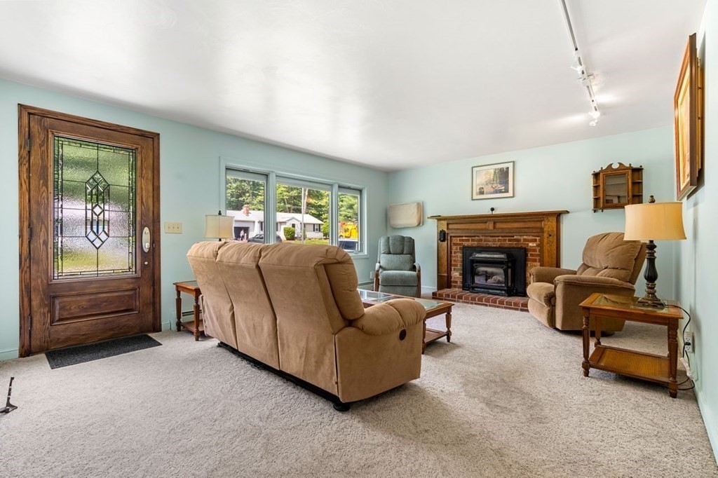 25 Pine Ridge Drive Ayer, MA 01432 - Photo 9 of 30 a living room with furniture and a fireplace