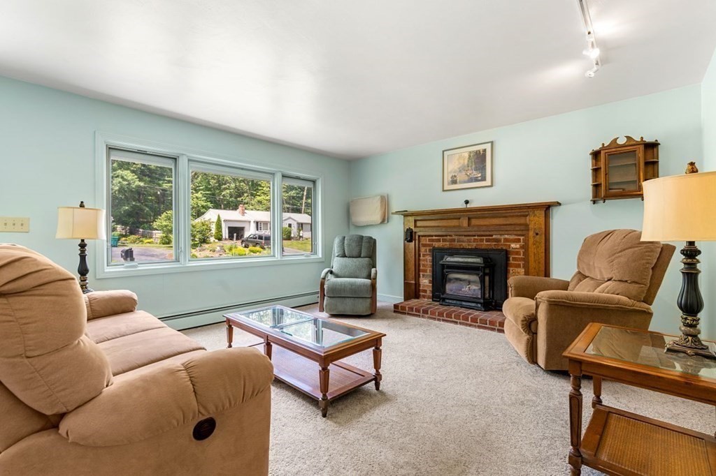 25 Pine Ridge Drive Ayer, MA 01432 - Photo 10 of 30 a living room with furniture a window and a fireplace