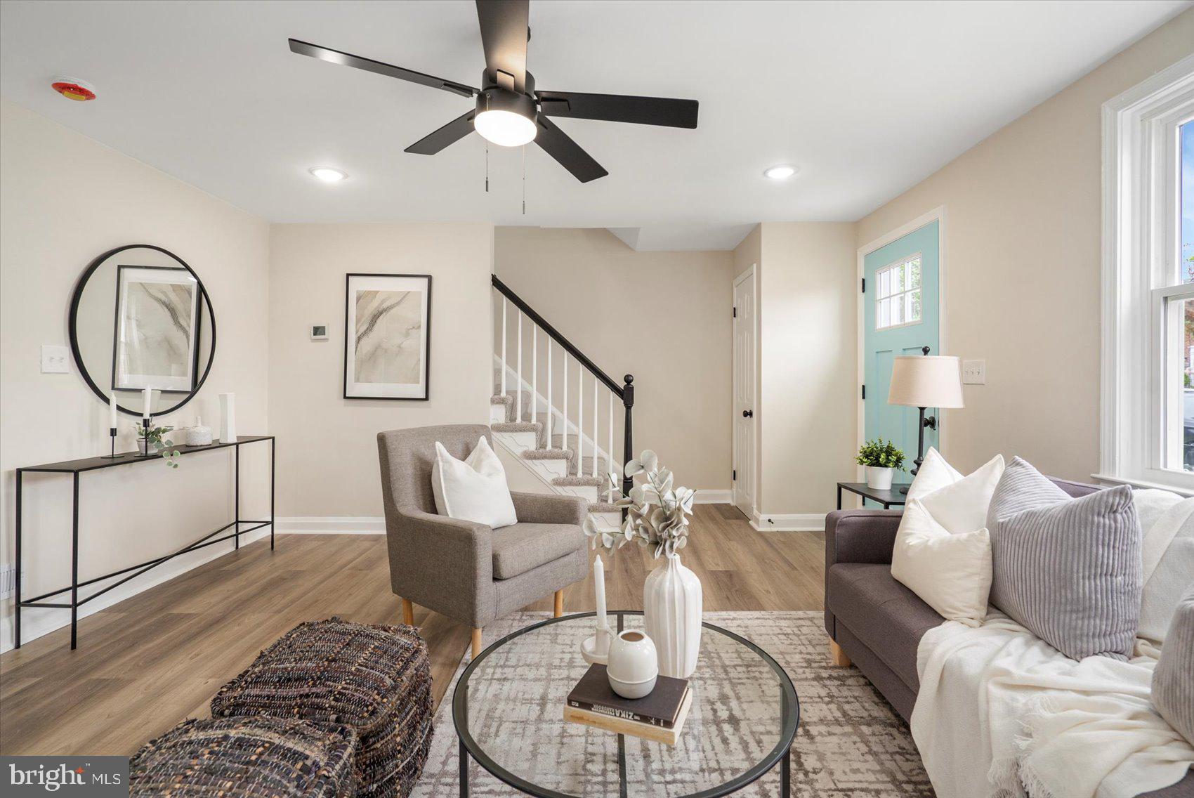 3531 Elmora Avenue Baltimore, MD 21213 - Photo 11 of 38 a living room with furniture a rug and a chandelier