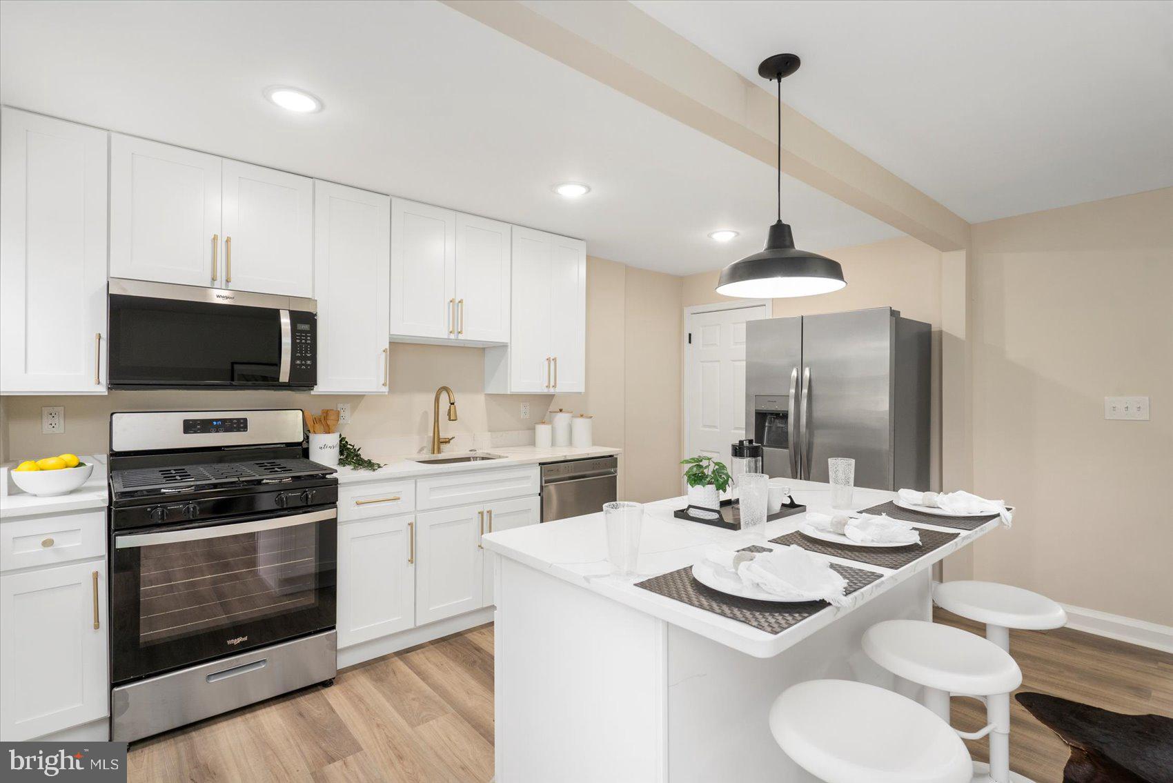 3531 Elmora Avenue Baltimore, MD 21213 - Photo 15 of 38 a kitchen with a sink stove and microwave