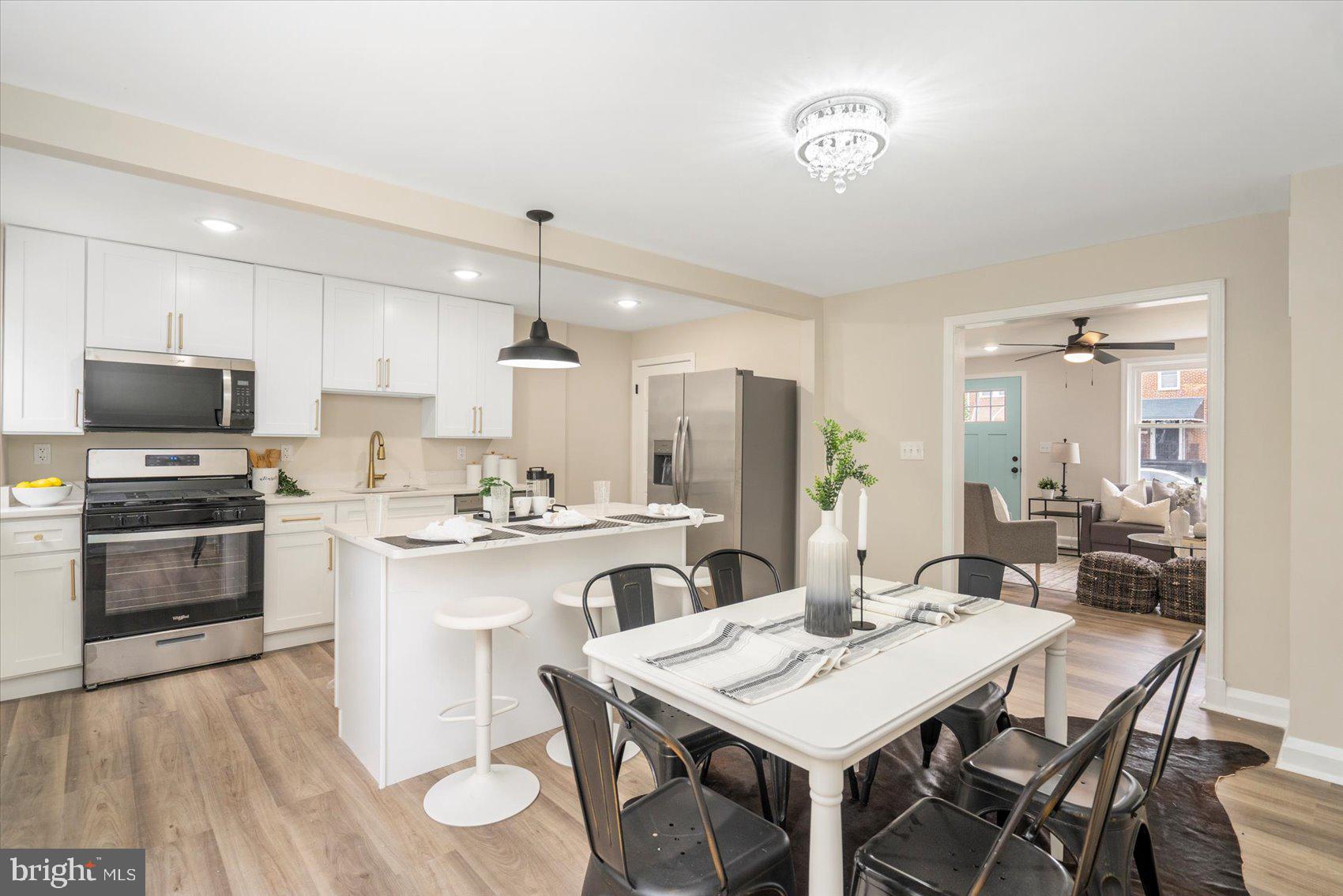 3531 Elmora Avenue Baltimore, MD 21213 - Photo 16 of 38 a kitchen with a dining table and chairs