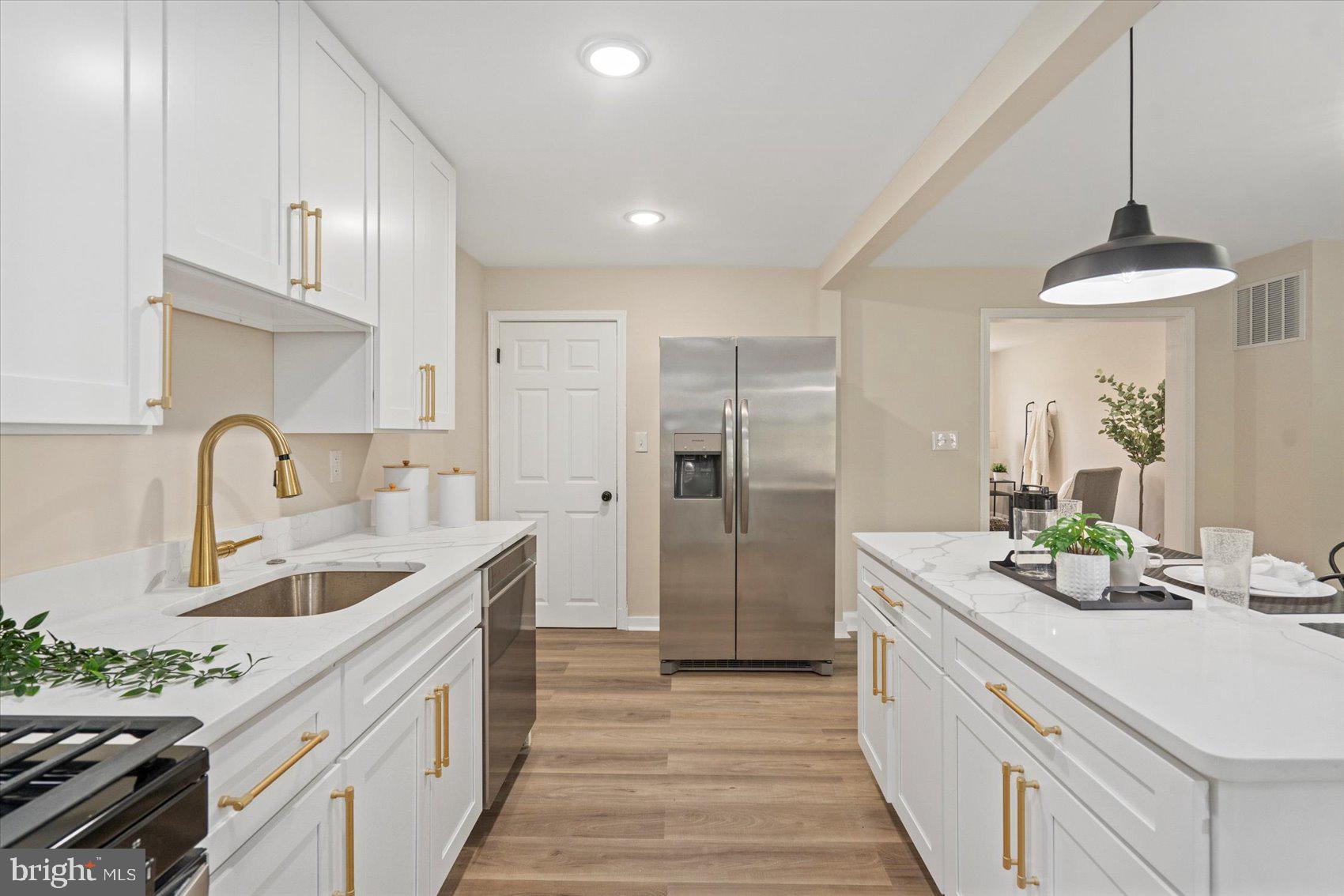 3531 Elmora Avenue Baltimore, MD 21213 - Photo 17 of 38 a kitchen with a sink and a refrigerator