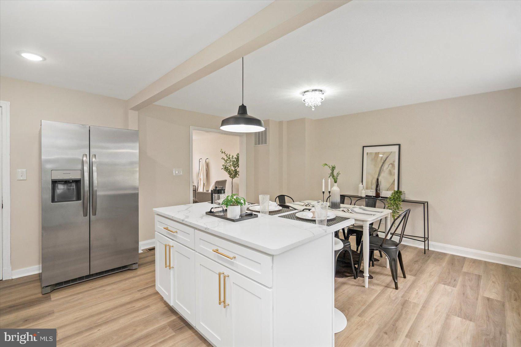 3531 Elmora Avenue Baltimore, MD 21213 - Photo 18 of 38 a view of dining table chairs and wooden floor