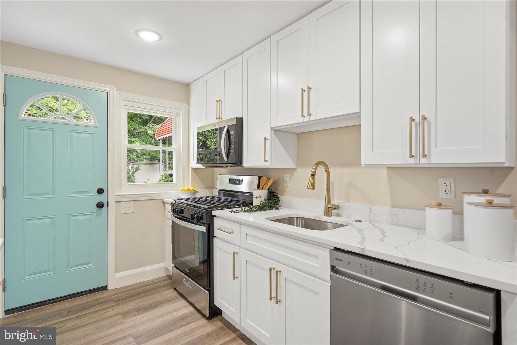 3531 Elmora Avenue Baltimore, MD 21213 - Photo 21 of 38 a kitchen with stainless steel appliances granite countertop a sink a stove a refrigerator and cabinets