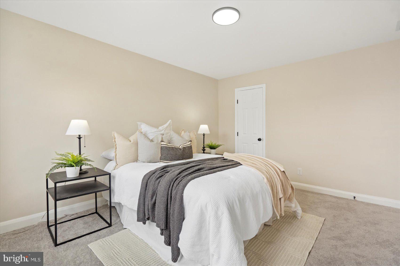 3531 Elmora Avenue Baltimore, MD 21213 - Photo 23 of 38 a bed room with a bed and a lamp