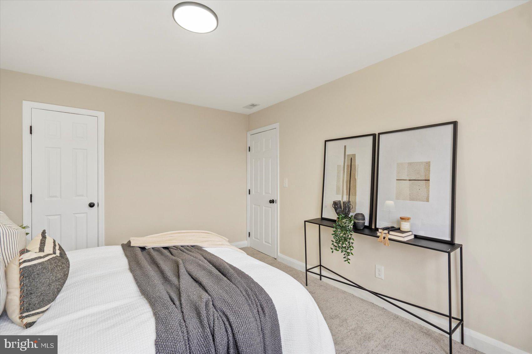 3531 Elmora Avenue Baltimore, MD 21213 - Photo 24 of 38 a bedroom with a bed and wooden floor