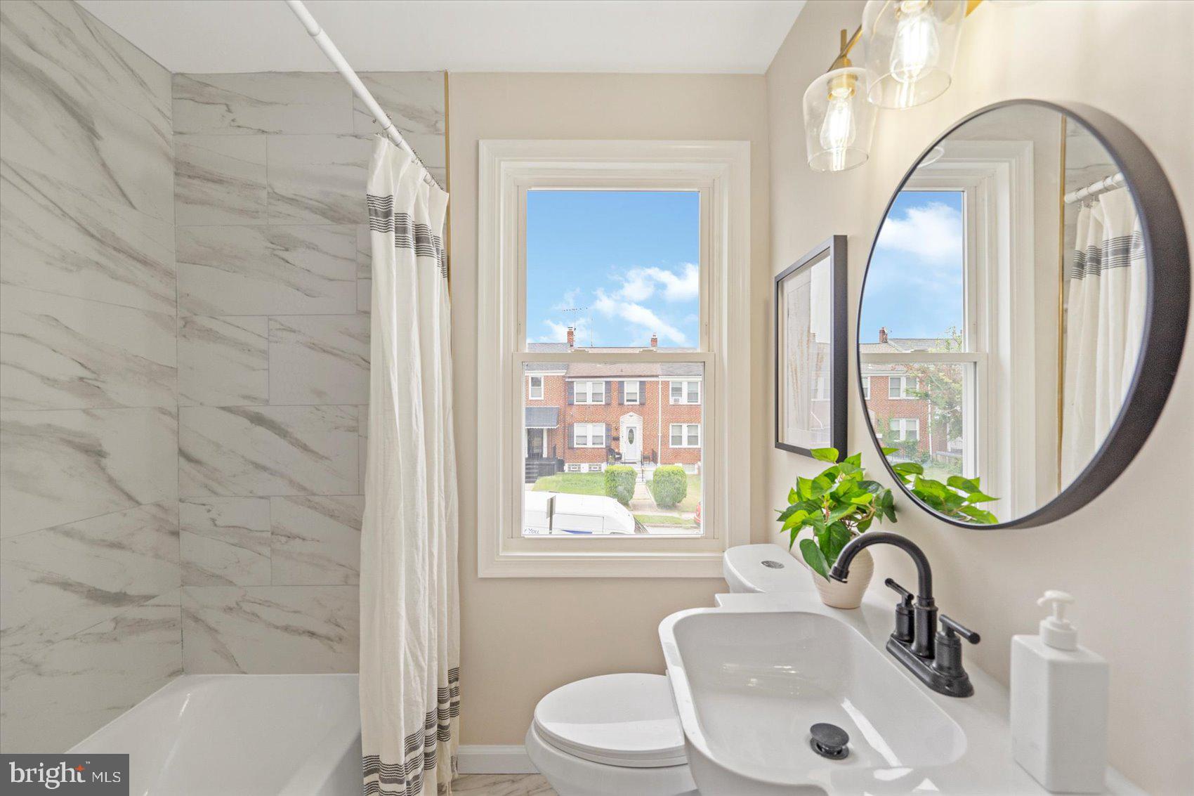 3531 Elmora Avenue Baltimore, MD 21213 - Photo 29 of 38 a bathroom with a sink and a mirror