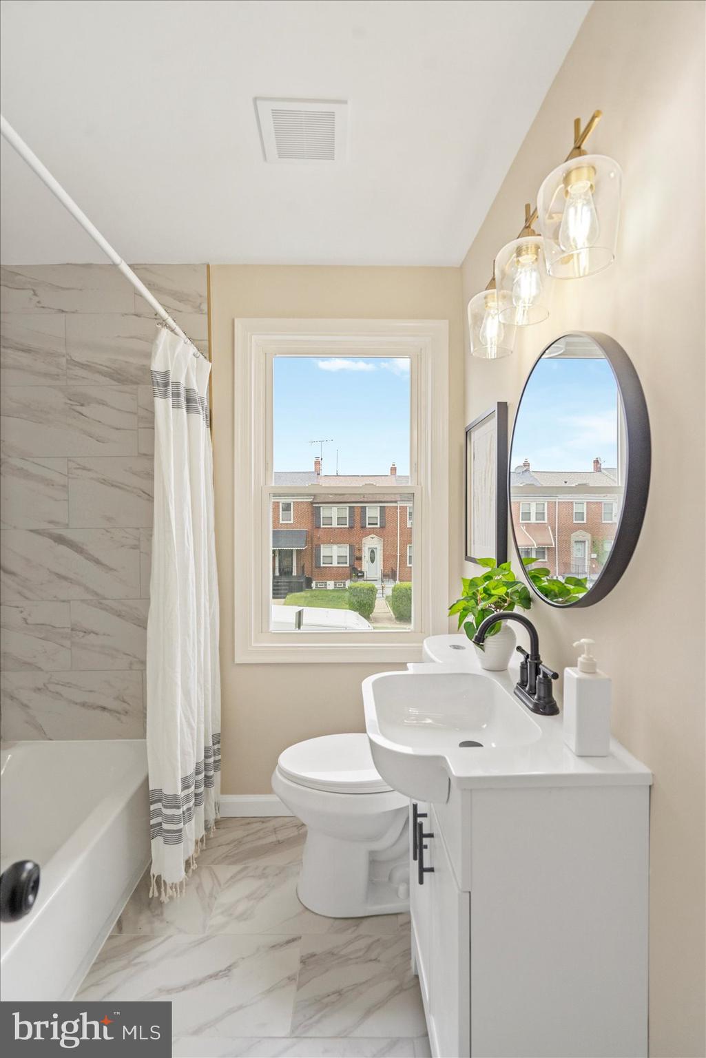 3531 Elmora Avenue Baltimore, MD 21213 - Photo 30 of 38 a bathroom with a sink a bathtub and a mirror