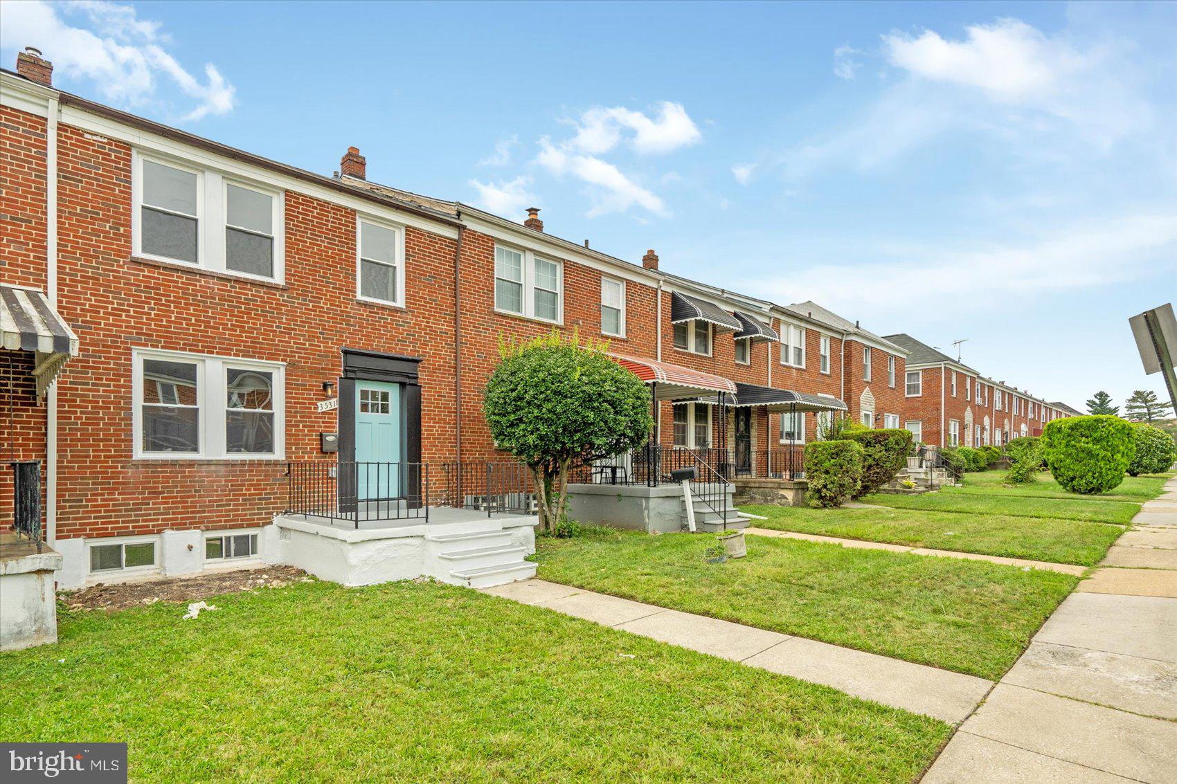 3531 Elmora Avenue Baltimore, MD 21213 - Photo 3 of 38 a front view of a building with a garden