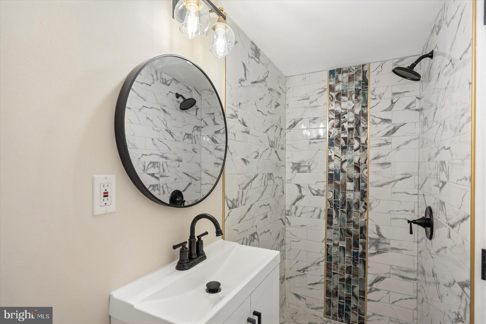 3531 Elmora Avenue Baltimore, MD 21213 - Photo 34 of 38 a bathroom with a sink and a mirror