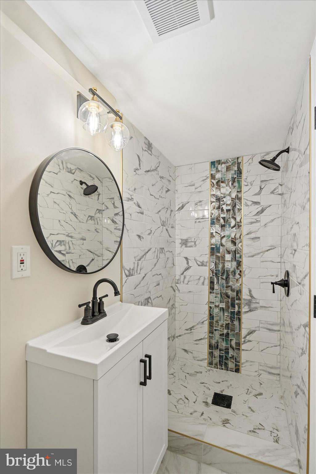 3531 Elmora Avenue Baltimore, MD 21213 - Photo 35 of 38 a bathroom with a sink and a mirror