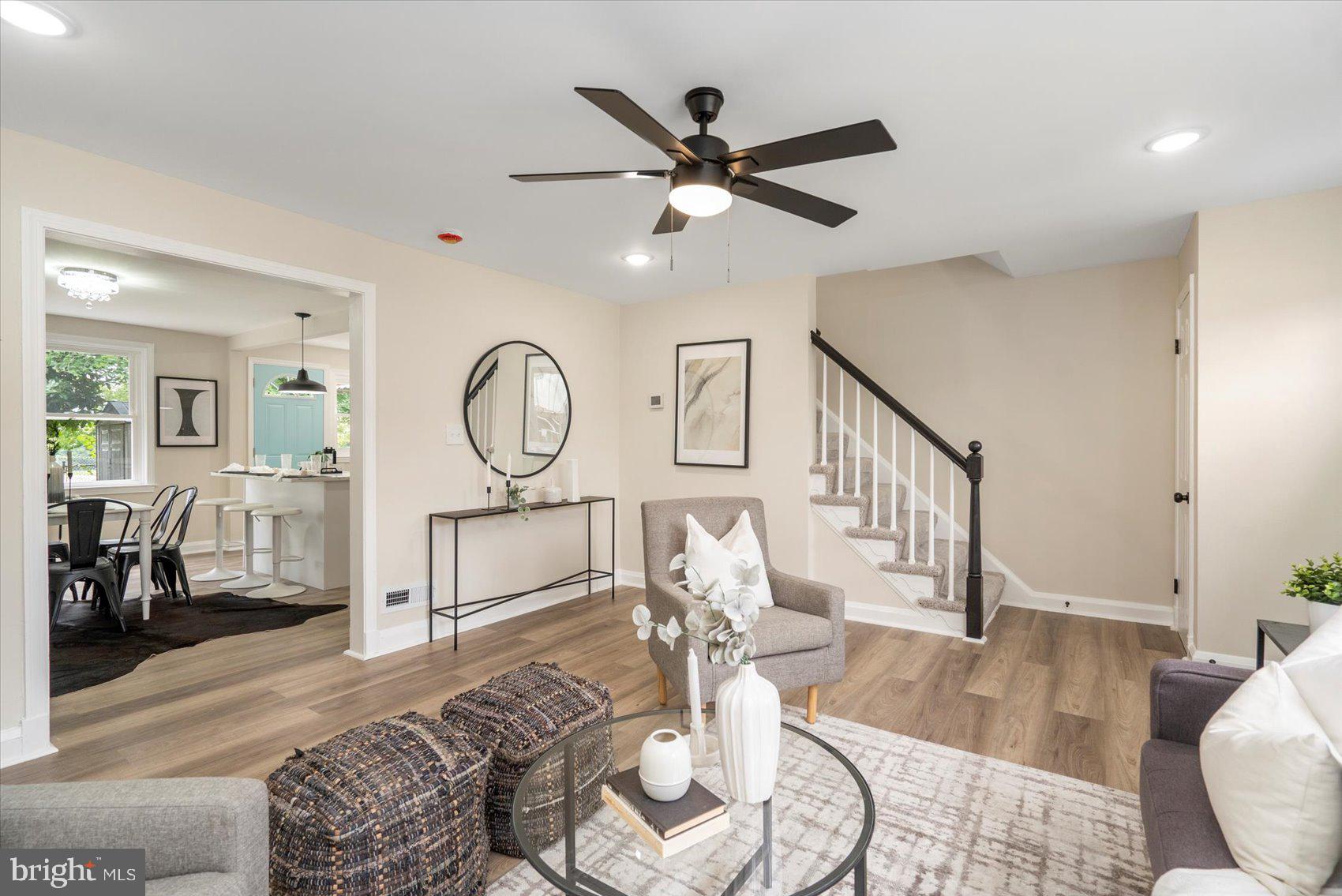 3531 Elmora Avenue Baltimore, MD 21213 - Photo 4 of 38 a living room with furniture a clock and wooden floor