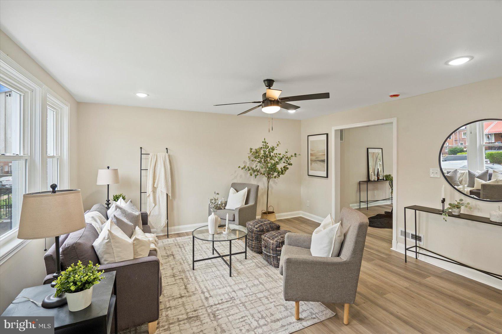 3531 Elmora Avenue Baltimore, MD 21213 - Photo 5 of 38 a living room with furniture and a chandelier