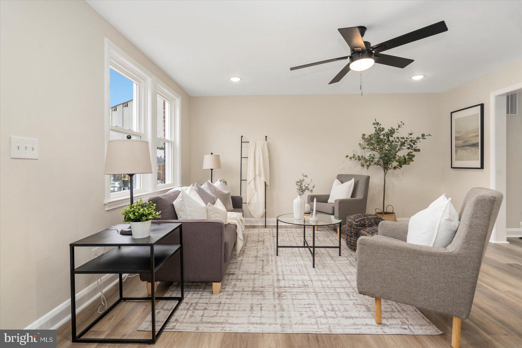 3531 Elmora Avenue Baltimore, MD 21213 - Photo 6 of 38 a living room with furniture a window and a potted plant