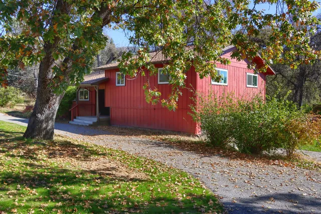 a view of a red house with a tree