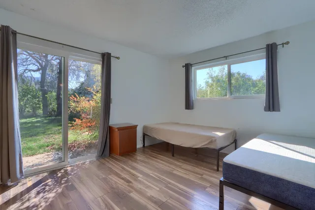 a view of a bathroom with a door and wooden floor