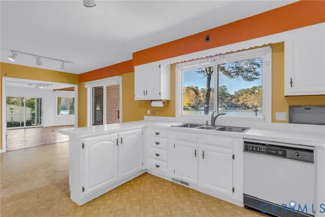 a view of kitchen with stainless steel appliances granite countertop cabinets and a potted plant