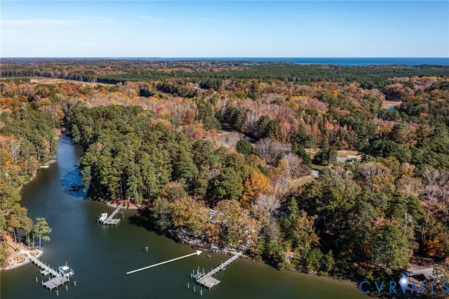 an aerial view of a houses with ocean view