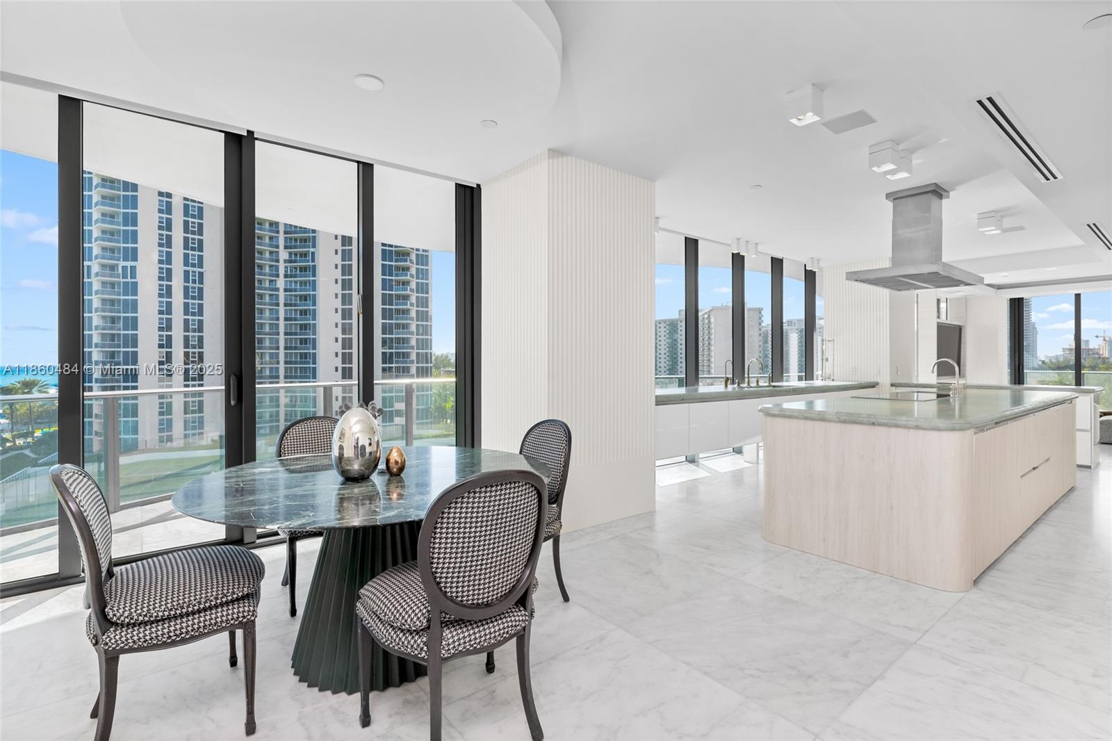 19575 Collins Avenue, Unit 6 Sunny Isles Beach, FL 33160 - Photo 14 of 42 a dining room with furniture and large windows