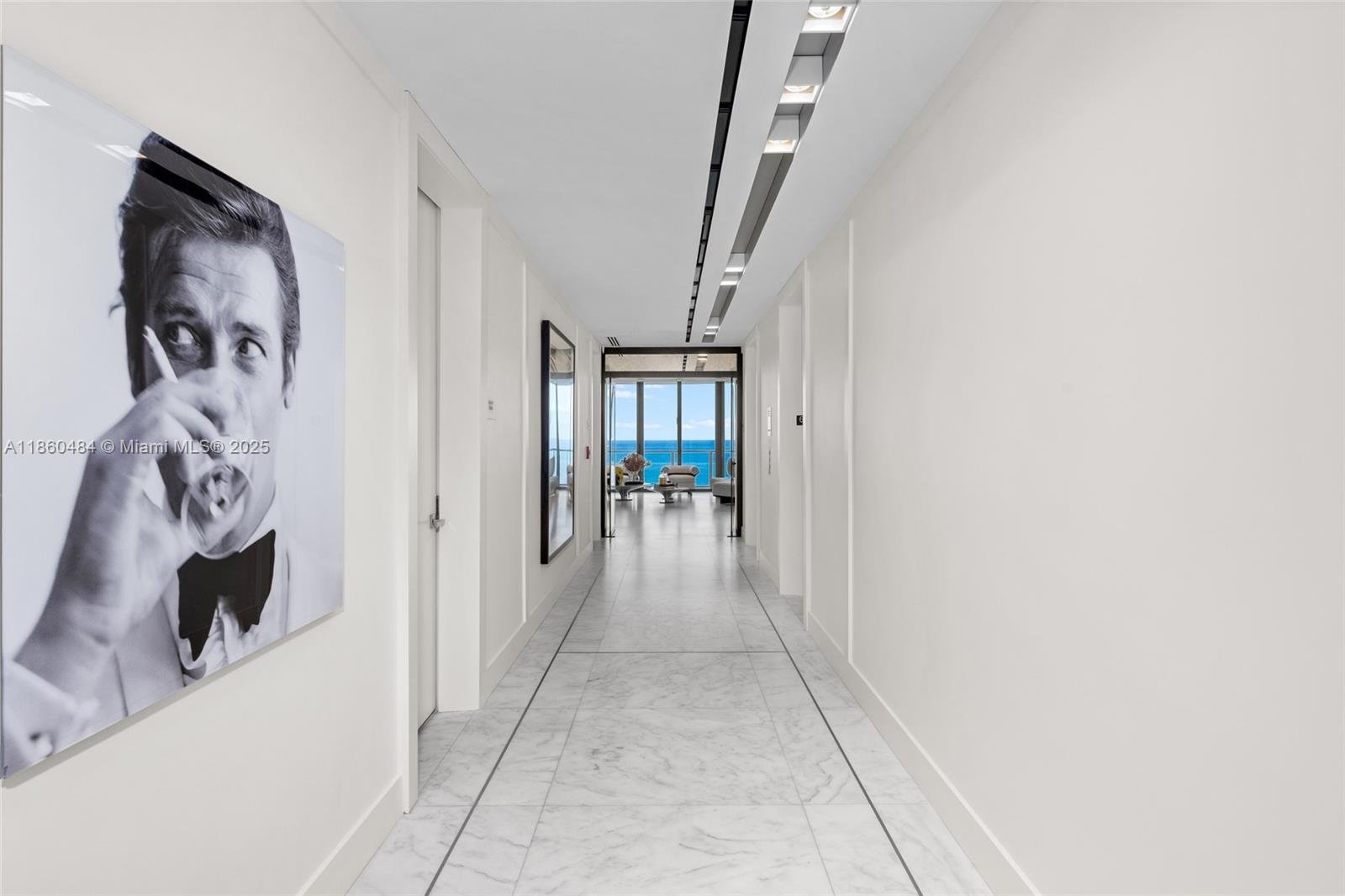 19575 Collins Avenue, Unit 6 Sunny Isles Beach, FL 33160 - Photo 2 of 42 a view of a hallway with wooden floor and a living room