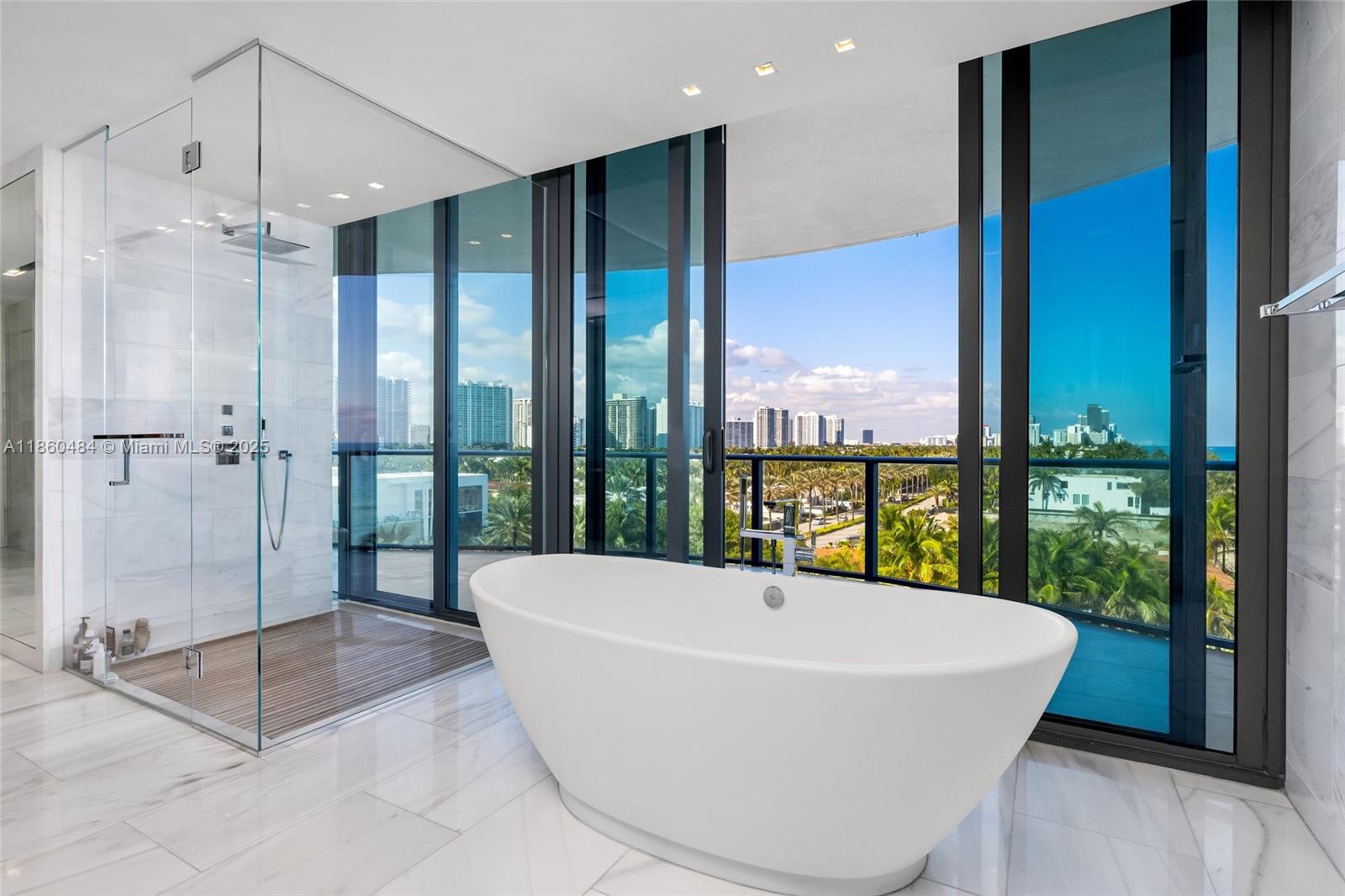 19575 Collins Avenue, Unit 6 Sunny Isles Beach, FL 33160 - Photo 22 of 42 a white bath tub sitting in front of a window