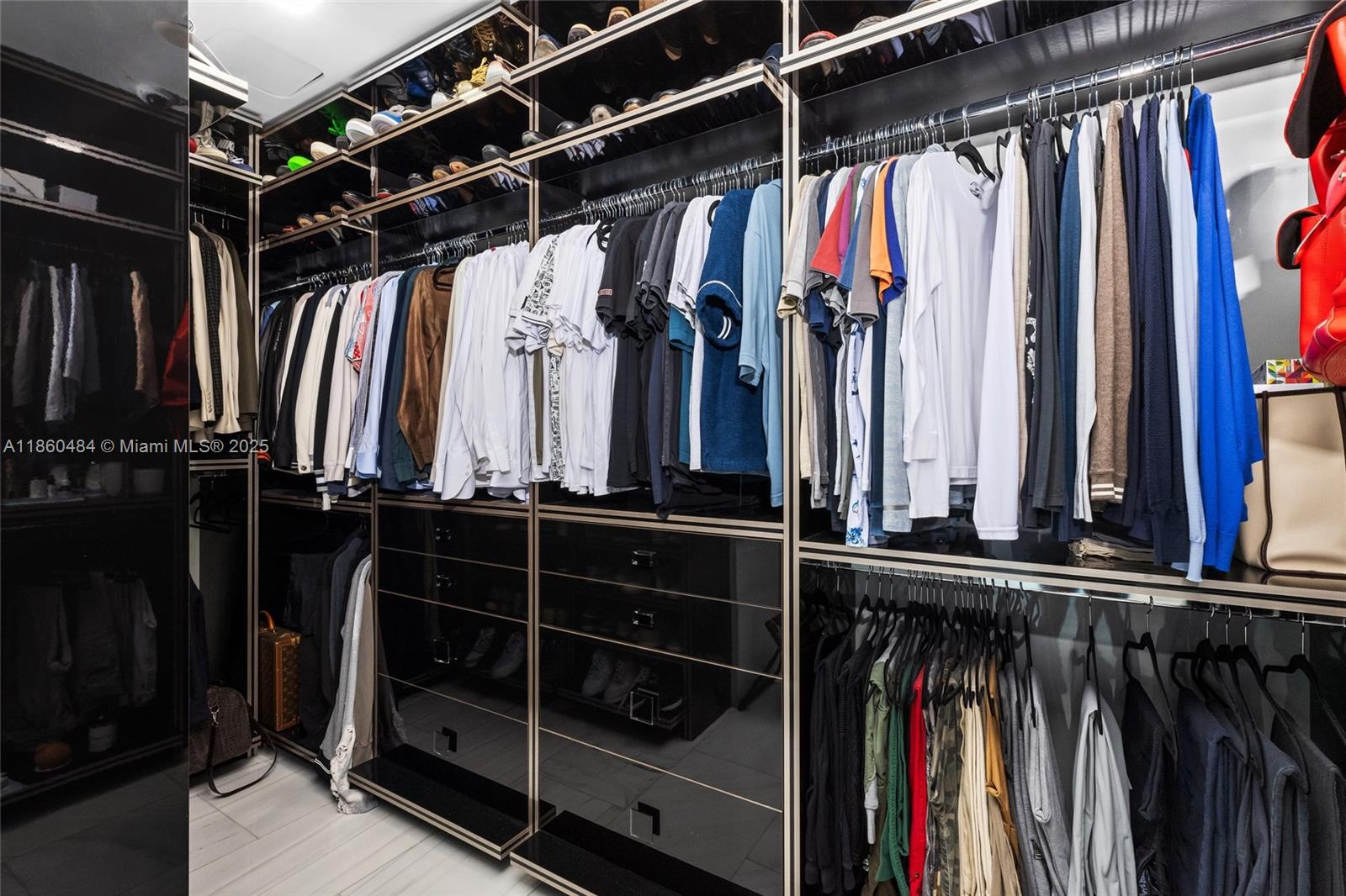 19575 Collins Avenue, Unit 6 Sunny Isles Beach, FL 33160 - Photo 25 of 42 a view of walk in closet with clothes and shoes