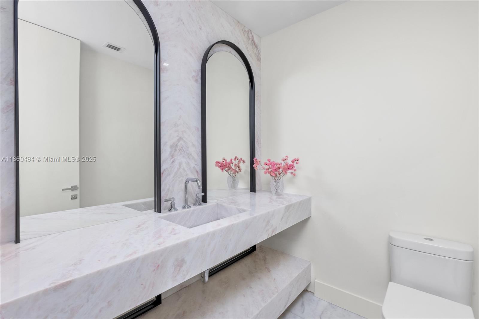 19575 Collins Avenue, Unit 6 Sunny Isles Beach, FL 33160 - Photo 10 of 42 a bathroom with a sink and a mirror