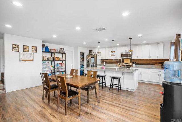 a view of kitchen with cabinets table and chairs