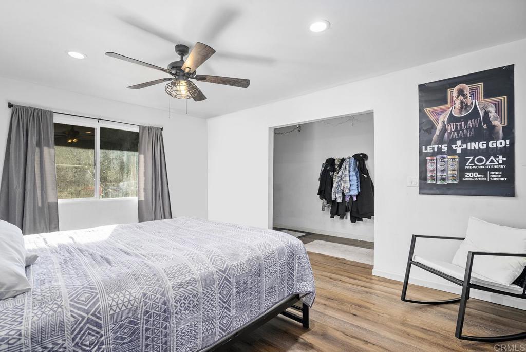 20591 Sycamore Springs Road Jamul, CA 91935 - Photo 18 of 53 a bedroom with a bed and a painting on the wall