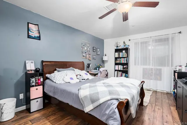 a bedroom with a bed and a book shelf