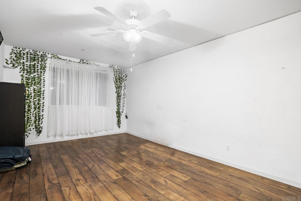 20591 Sycamore Springs Road Jamul, CA 91935 - Photo 25 of 53 an empty room with wooden floor fan and windows