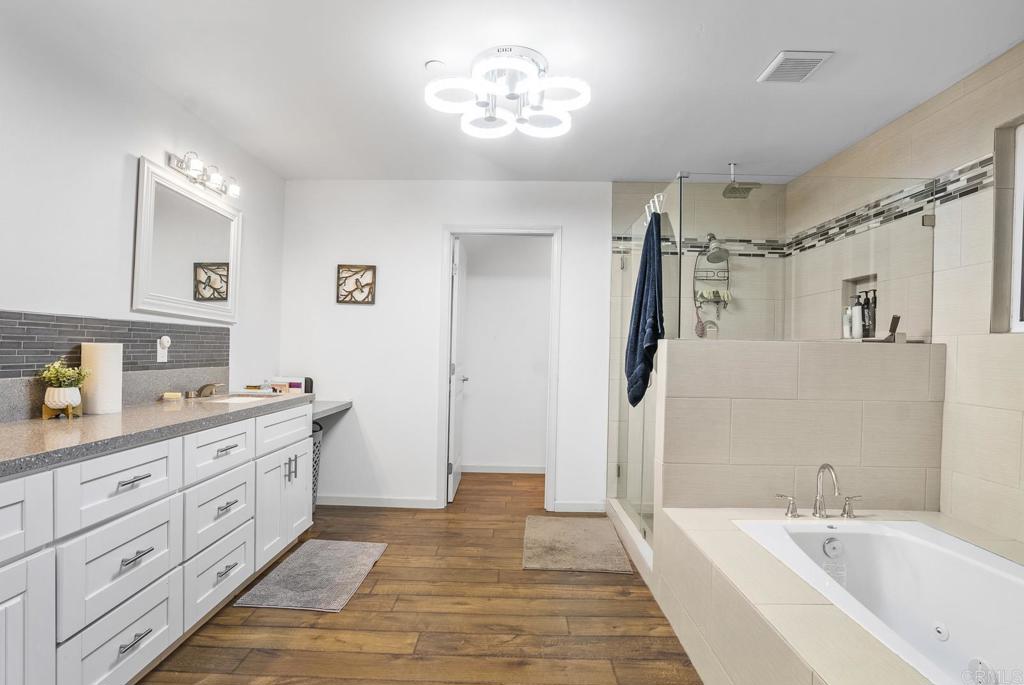 20591 Sycamore Springs Road Jamul, CA 91935 - Photo 29 of 53 a spacious bathroom with a tub sink and mirror