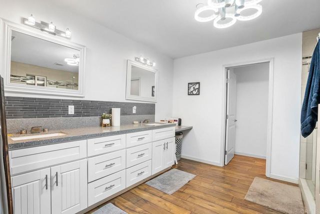 a spacious bathroom with a granite countertop sink a mirror and a