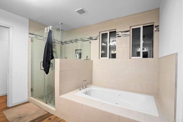a bathroom with a tub a sink and shower