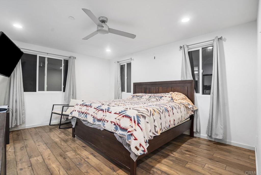 20591 Sycamore Springs Road Jamul, CA 91935 - Photo 32 of 53 a bed sitting in a bedroom next to a window with pc on the wall