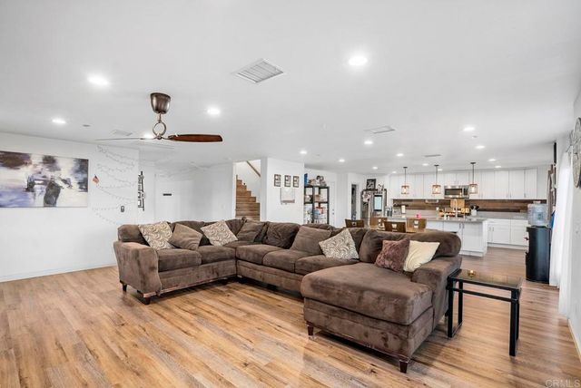 a living room with furniture and kitchen view