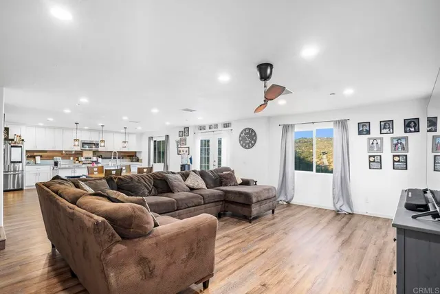 a living room with furniture and wooden floor