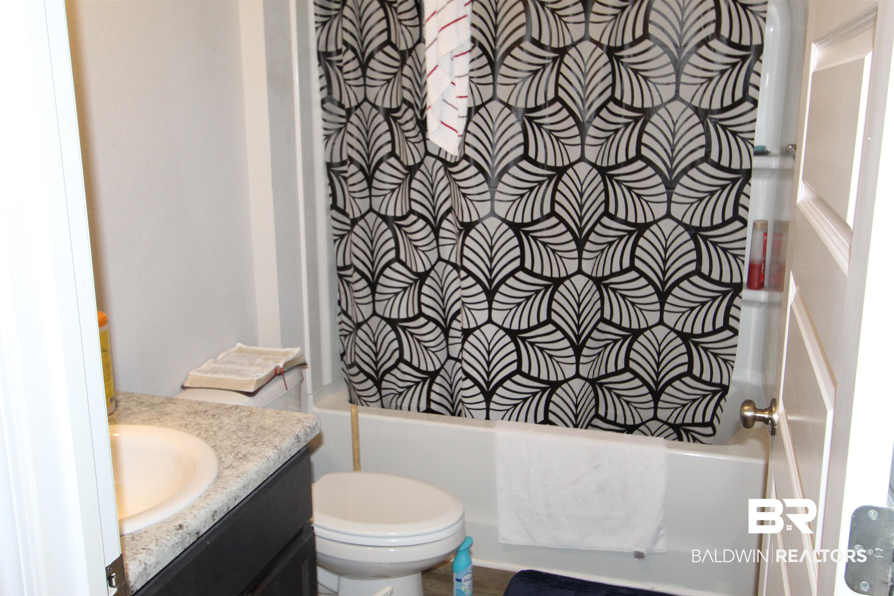 1502 Majesty Loop Foley, AL 36535 - Photo 23 of 26 Full bathroom featuring vanity, toilet, and washtub / shower combination