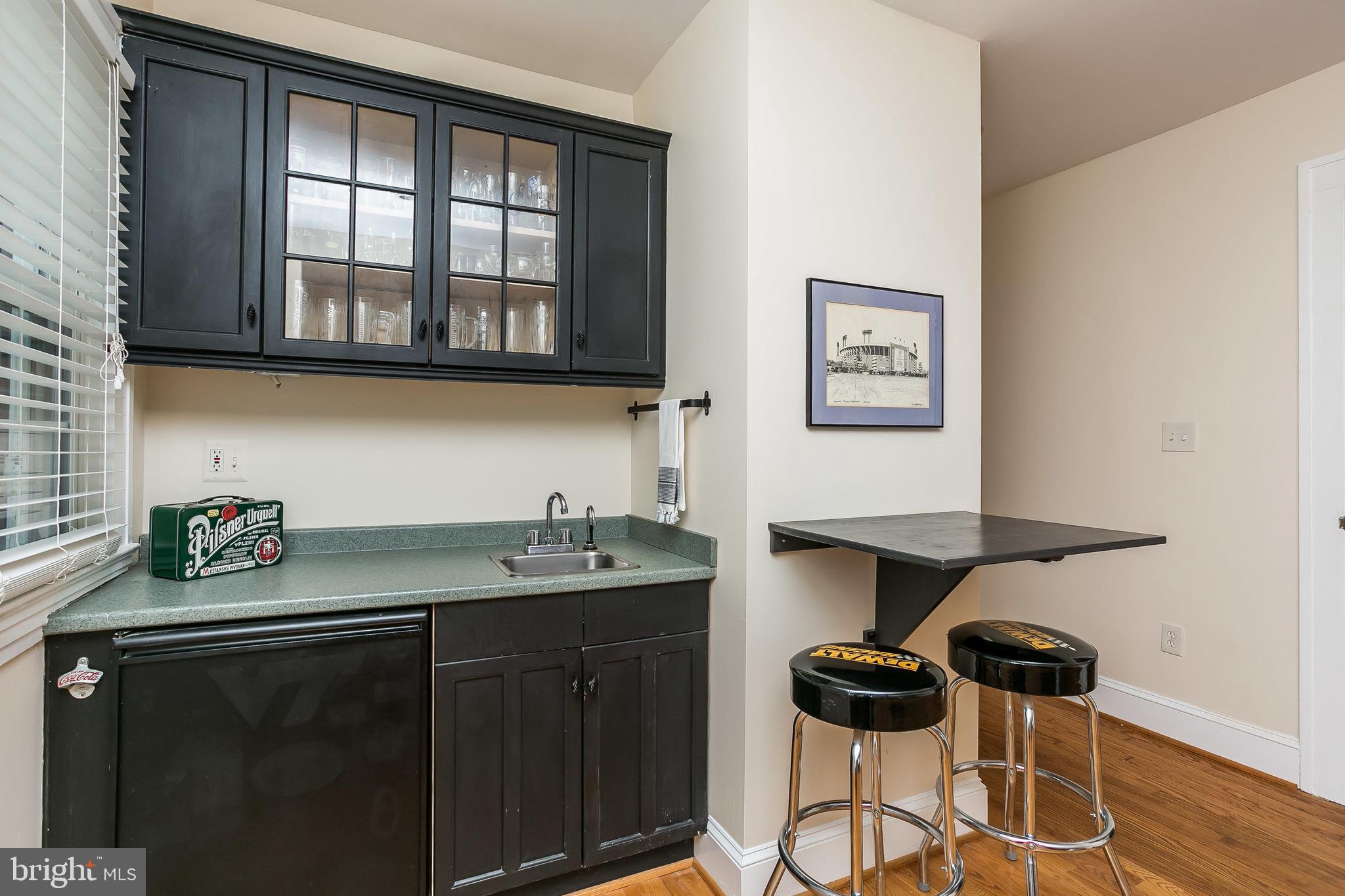 6407 Pinehurst Road Baltimore, MD 21212 - Photo 22 of 50 Wetbar in game room with sink and refrigerator