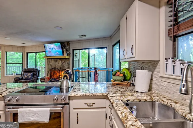 a living room with furniture a flat screen tv and a dining table