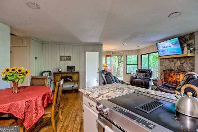 a living room with furniture a flat screen tv and a large window
