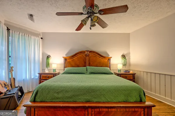 a bathroom with a sink a toilet and shower curtain