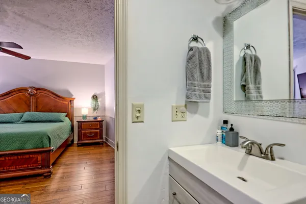 a view of hallway with wooden floor and stairs