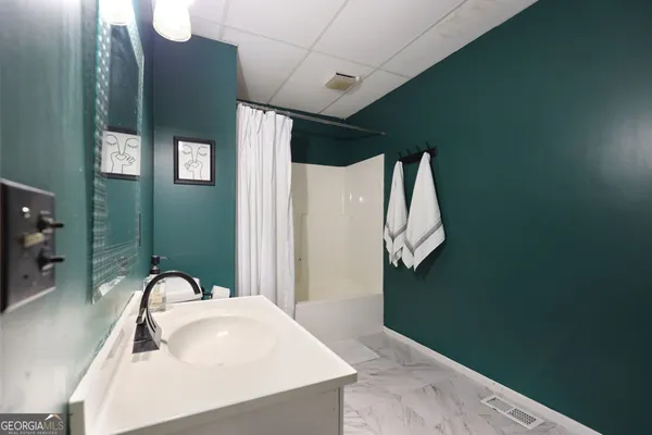 a bathroom with a toilet a sink and mirror