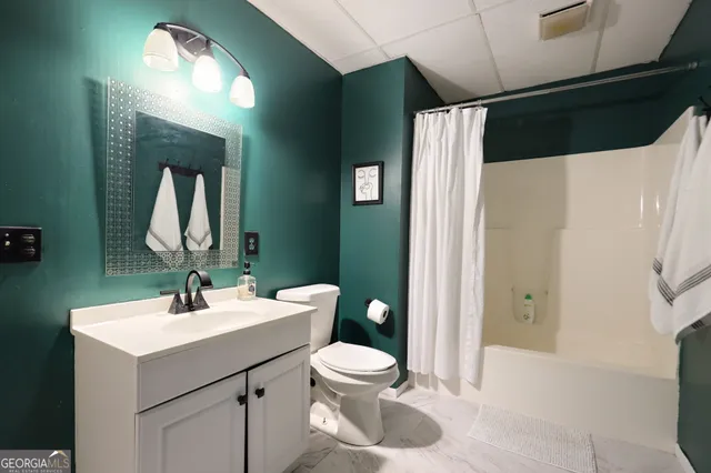 a living room with furniture a flat screen tv and a window