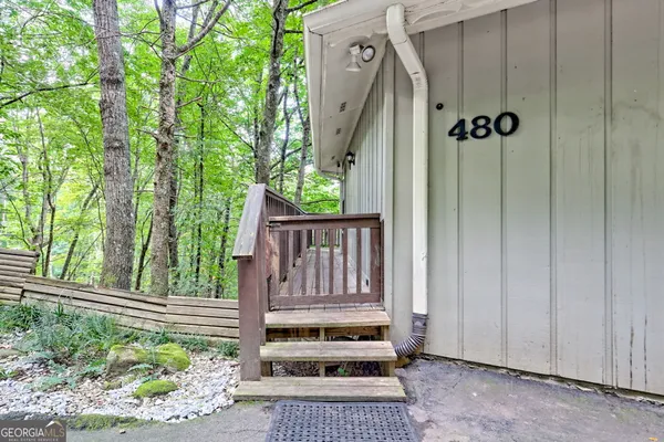 a view of a house with a door and wooden floor